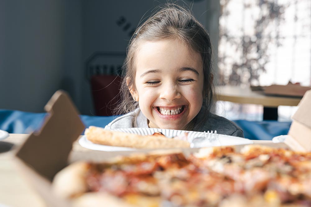 happy-little-girl-looks-at-pizza-with-appetite-2025-03-15-06-05-22-utc.jpg