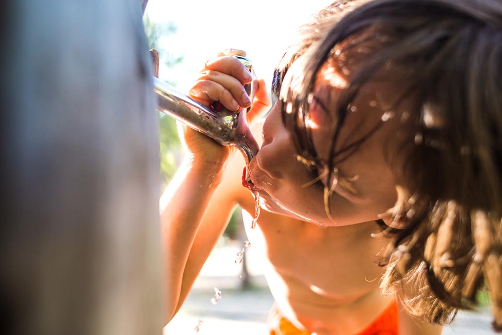 thirsty-child-drinks-from-outdoor-water-fountain-2026-03-26-09-52-58-utc.jpg