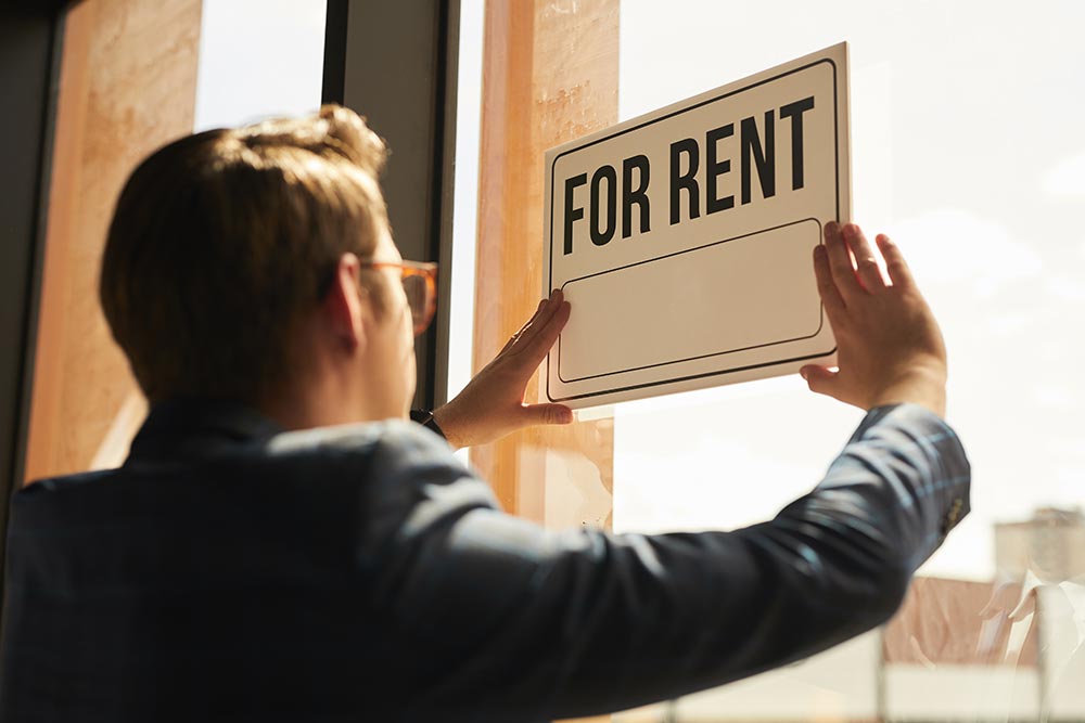 real-estate-agent-hanging-for-rent-sign-2026-03-19-23-49-45-utc.jpg