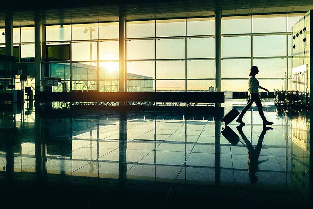 woman-with-suitcase-walking-through-an-airport-ter-2026-03-24-06-52-14-utc.jpg