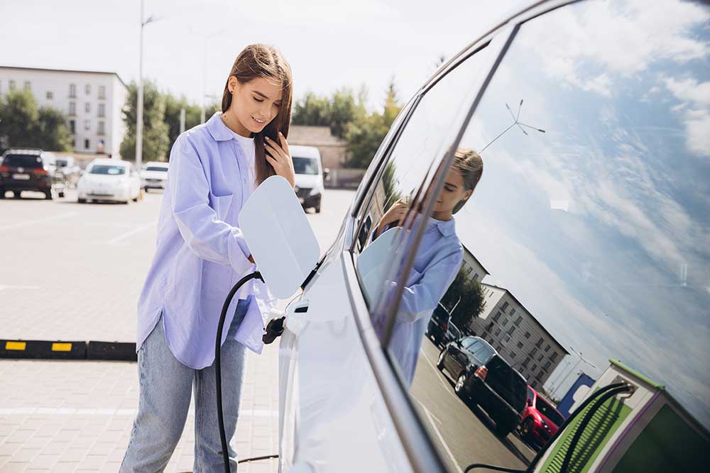 young-woman-charging-electric-car-at-station-in-ur-2024-10-16-01-01-44-utc.jpg