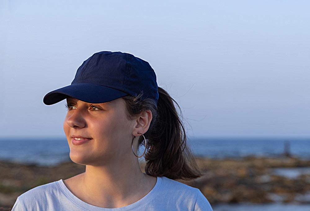 teen-girl-in-dark-blue-baseball-cap-at-sunset-2025-03-16-12-38-12-utc.jpg