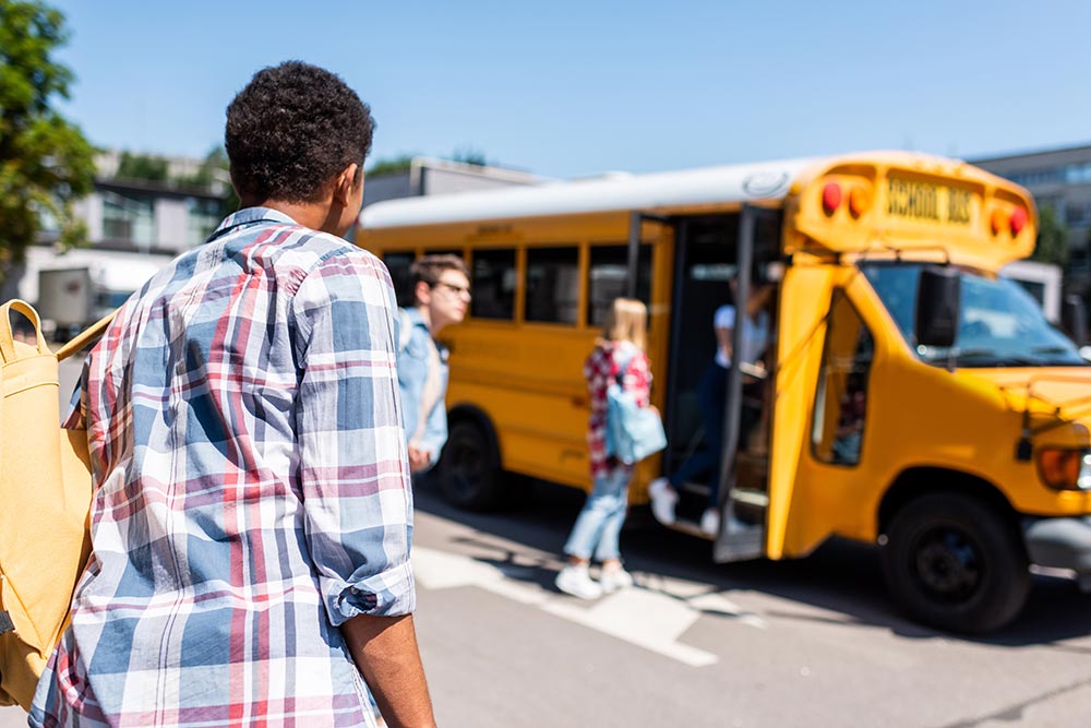 rear-view-of-teen-african-american-schoolboy-walki-2024-11-19-15-16-34-utc.jpg