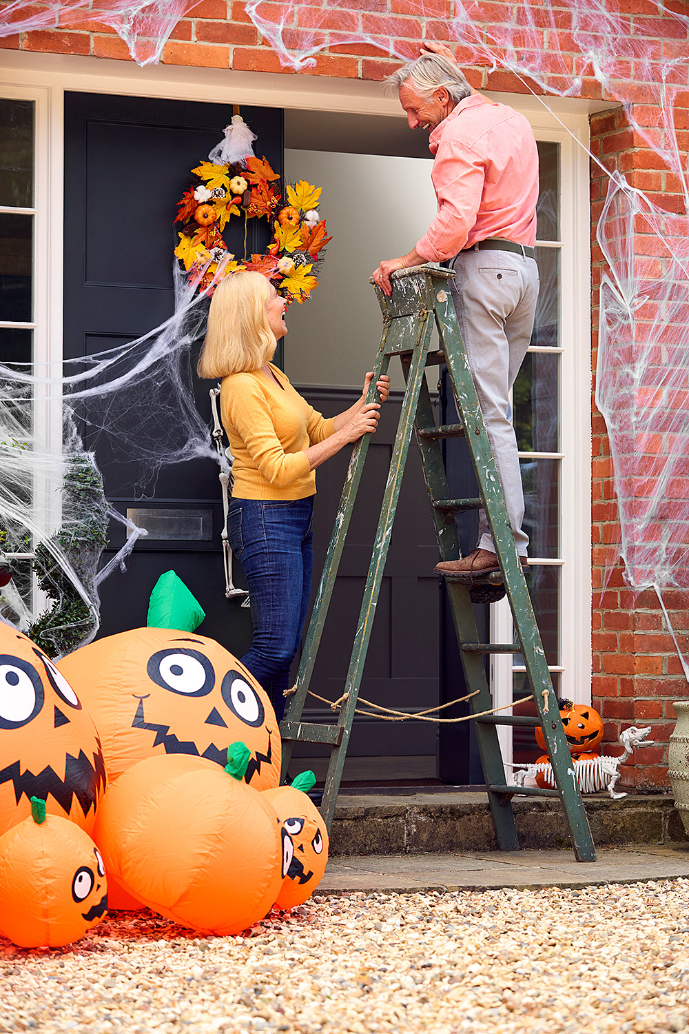 grandparents-at-home-putting-up-halloween-decorati-2024-10-19-10-25-20-utc.jpg