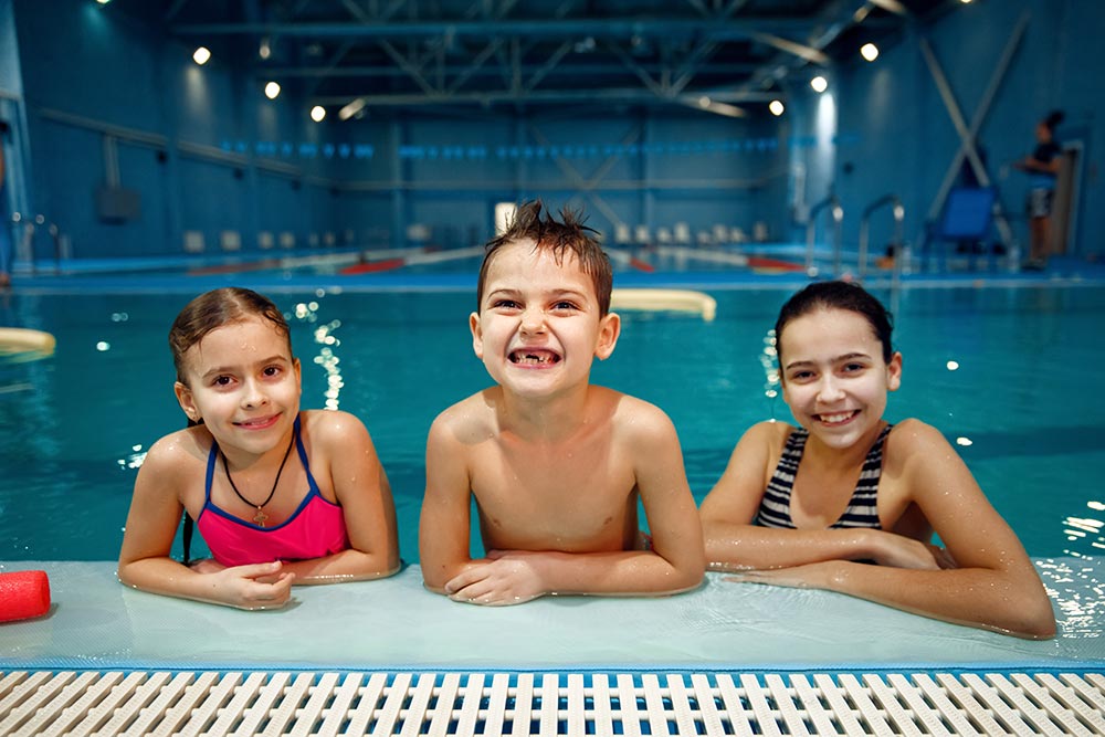 smiling-children-group-poses-at-the-poolside-2024-11-26-09-43-23-utc.jpg