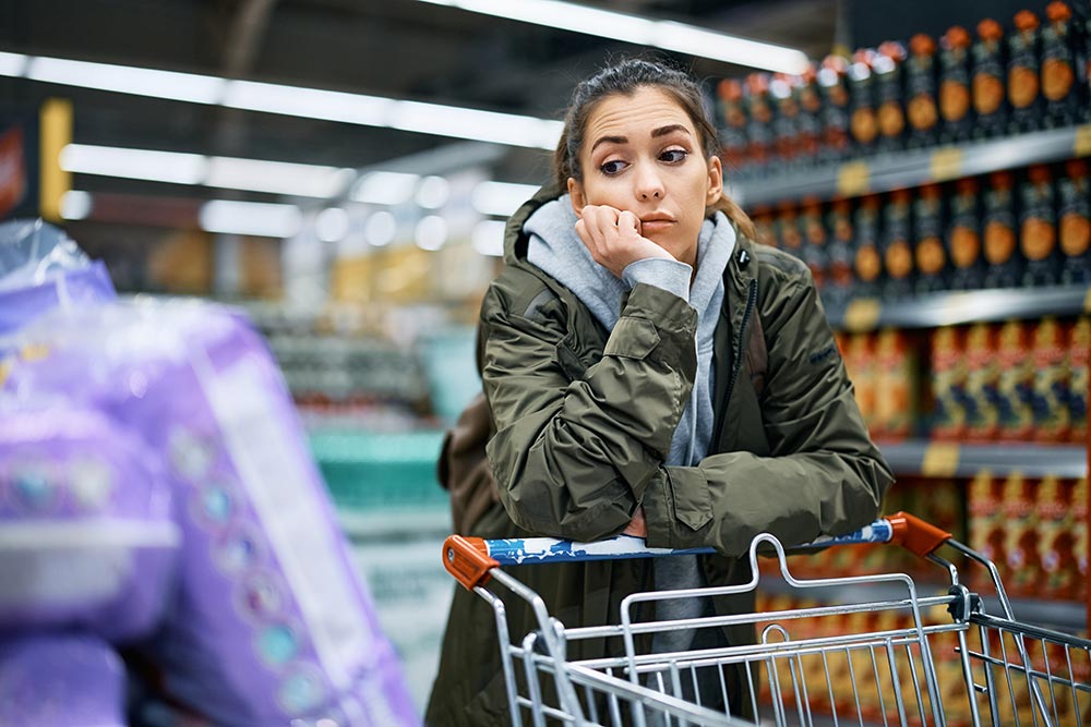 young-worried-woman-looking-at-rising-prices-while-2024-12-13-18-32-21-utc.jpg