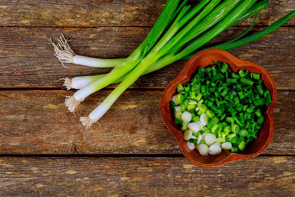 scallion-on-wood-background-and-cut-green-ono-in-w-2023-11-27-05-32-36-utc.jpg