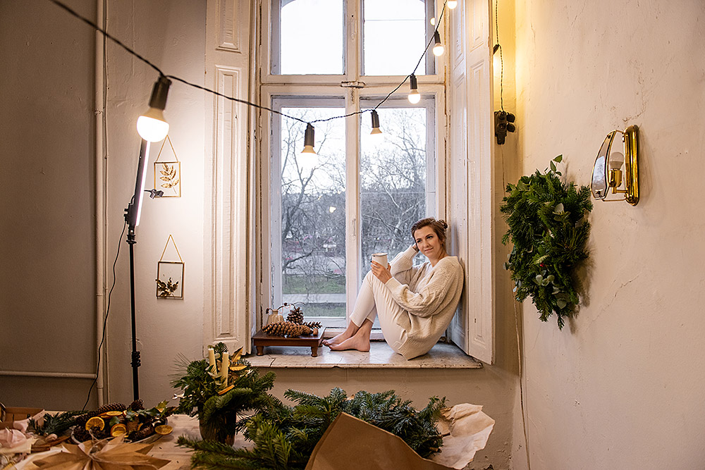 young-woman-blogger-sits-on-windowsill-near-window-2025-03-15-03-08-21-utc.jpg