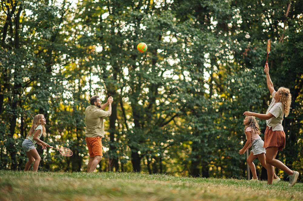 family-having-sports-day-in-nature-playing-badmint-2024-04-09-18-37-00-utc.jpg