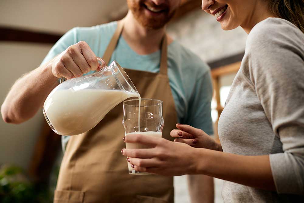 close-up-of-man-pouring-milk-into-girlfriend-s-gla-2024-12-13-17-07-49-utc.jpg