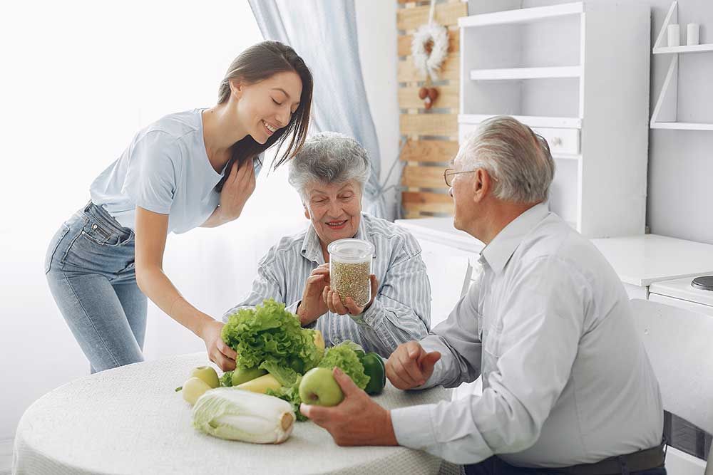 old-couple-in-a-kitchen-with-young-granddaughter-2024-12-07-00-02-45-utc.jpg