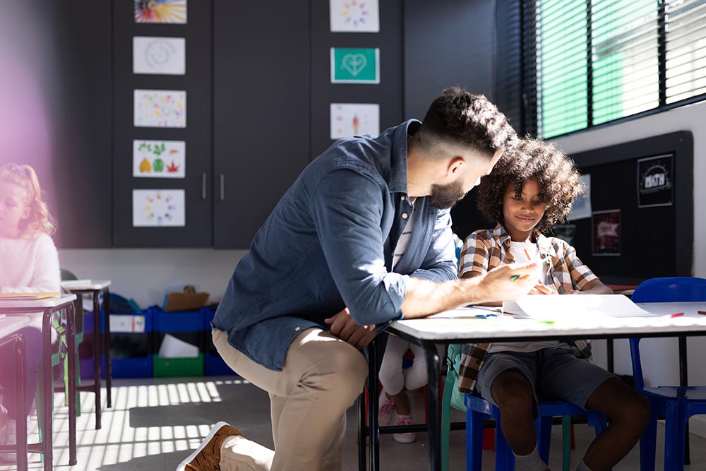 diverse-male-teacher-helping-happy-smiling-boy-at-2026-01-09-09-37-47-utc.jpg