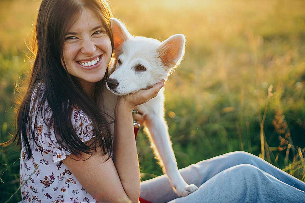 happy-woman-hugging-cute-white-puppy-in-summer-mea-2025-03-16-11-27-37-utc.JPG